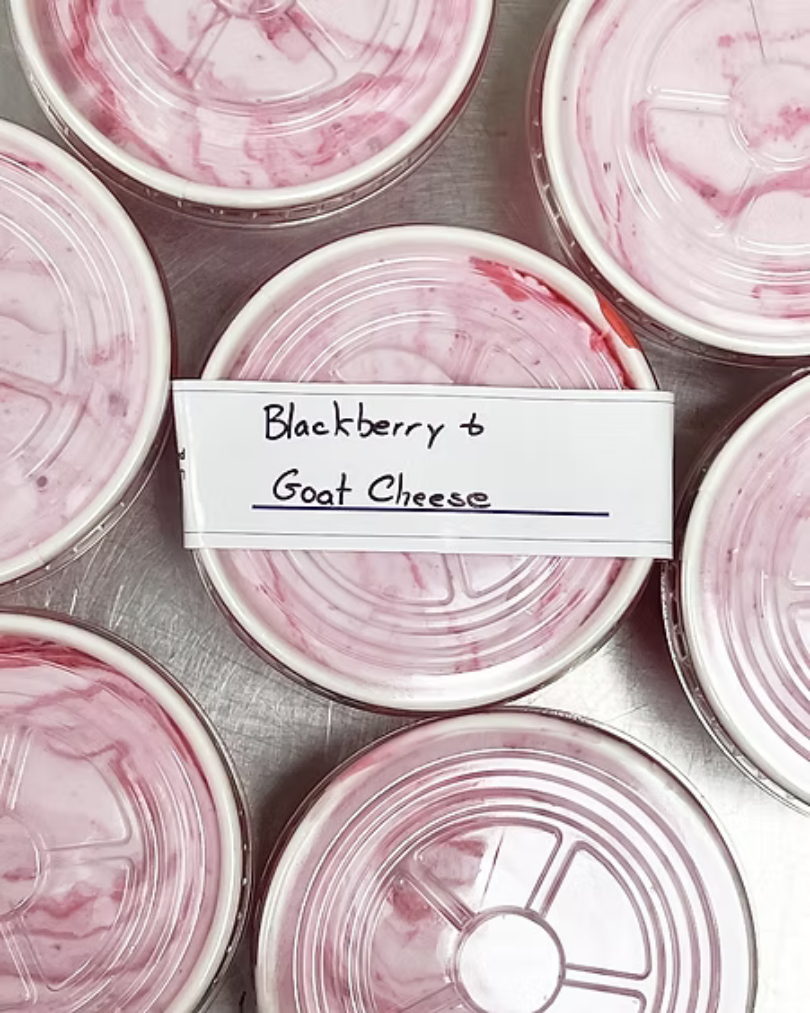 Blackberry and goat cheese ice cream in hand-packed containers, showcasing unique flavors from Hugs Ice Cream for events and gatherings.